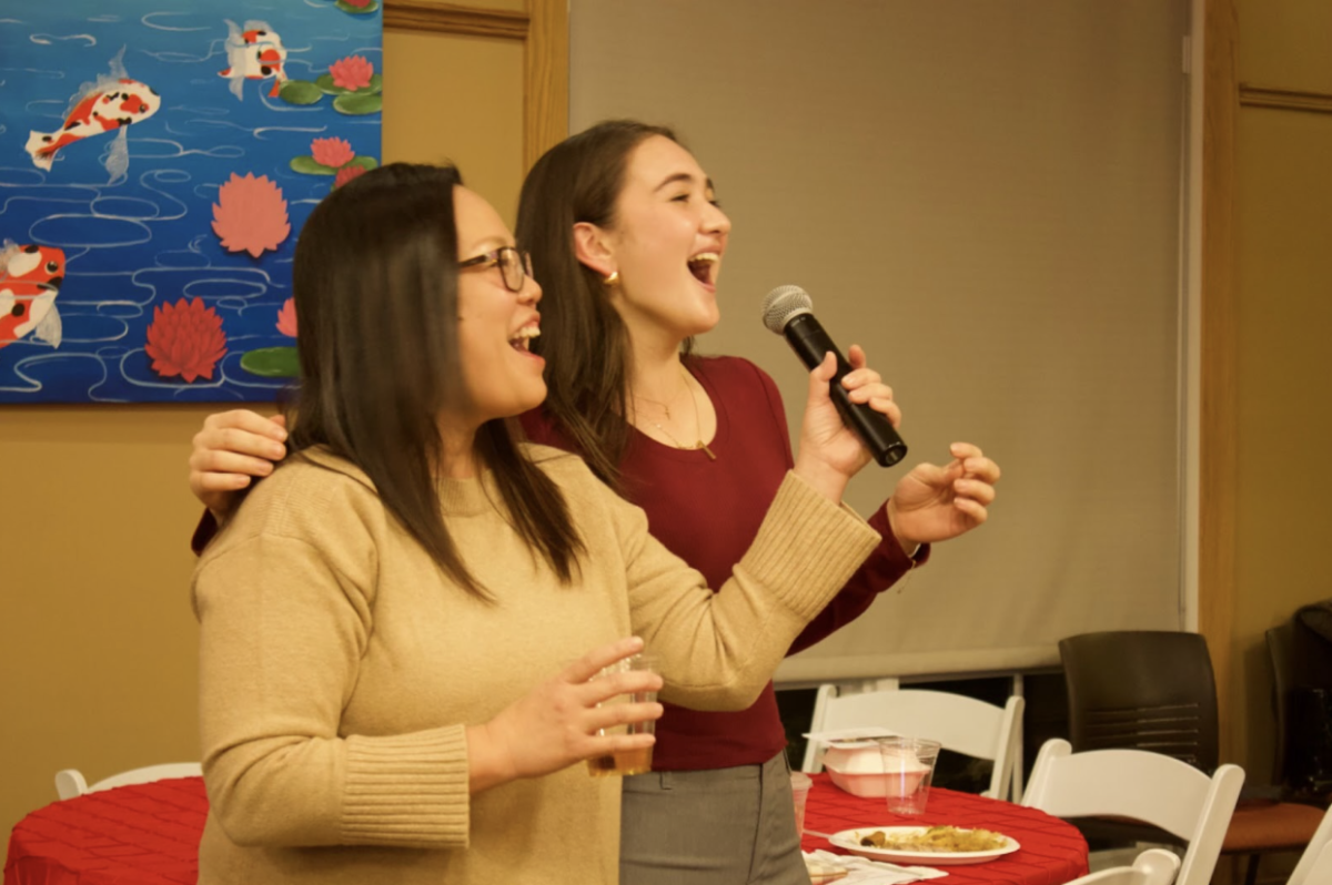 Voices blend together as Kennedy Taylor 25’ and alum Maritess Lacuesta Kinderman’ 93 invite the room to partake in the beloved Filipino party tradition of karaoke.